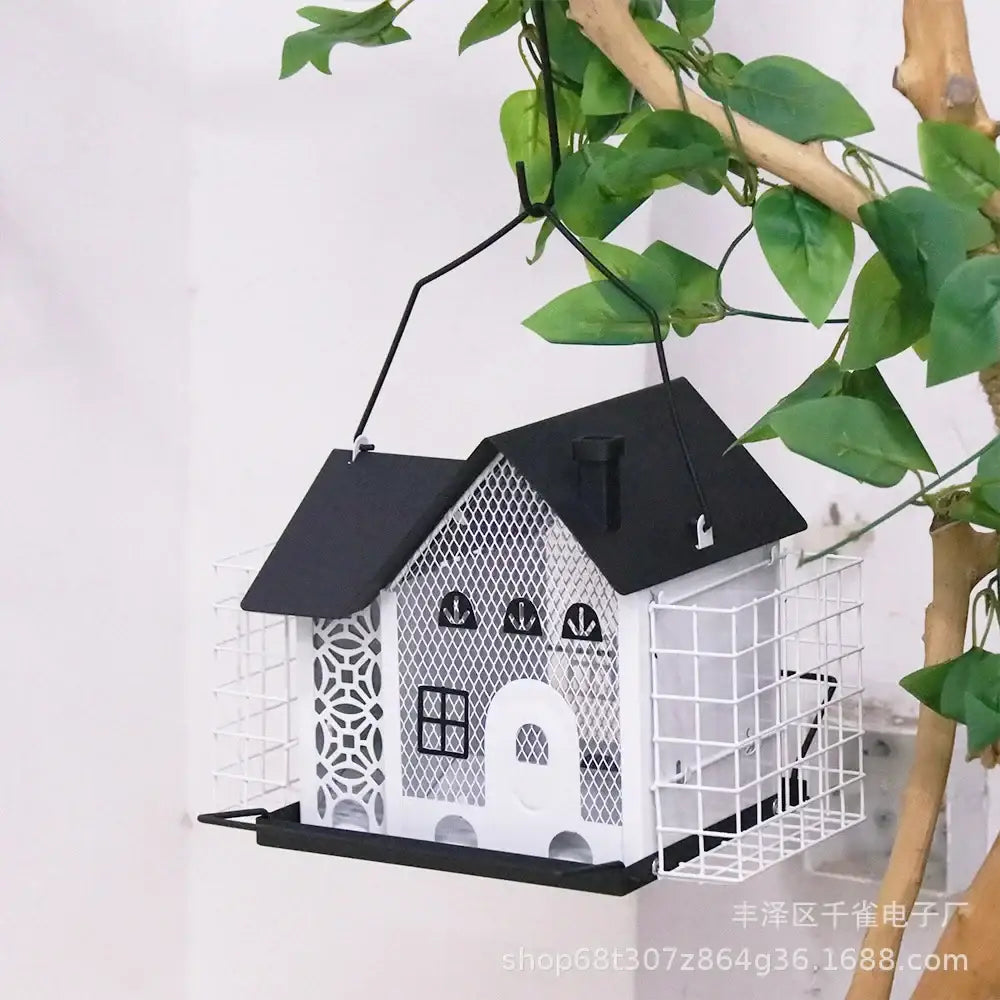Black and white hanging metal bird feeder shaped like a house with decorative lattice windows by decorbites hanging metal