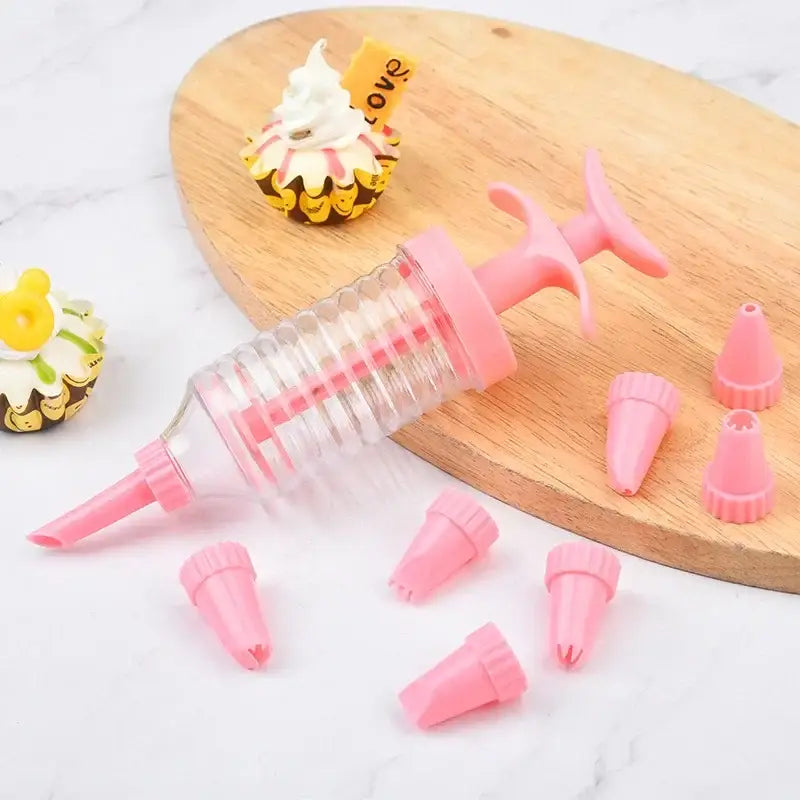 Pink plastic cream cake press with clear barrel and pink nozzles for decorbites cookie cream kitchen decorating kit