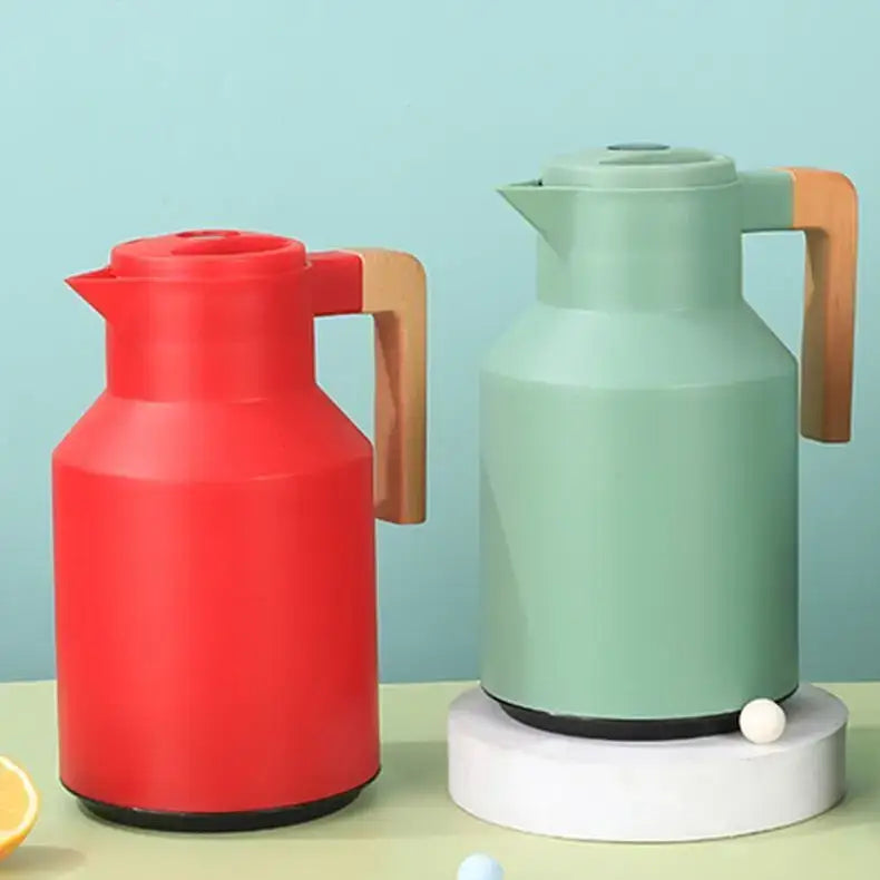 Red and mint green insulated water thermos kettles with wooden handles for kitchen use