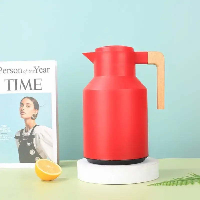 Red insulated water thermos kettle with wooden handle and black base for kitchen use as an insulated water thermos