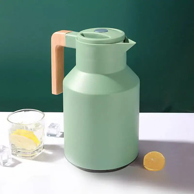 Mint green insulated water thermos kettle with light wood handle and sleek modern design for kitchen use