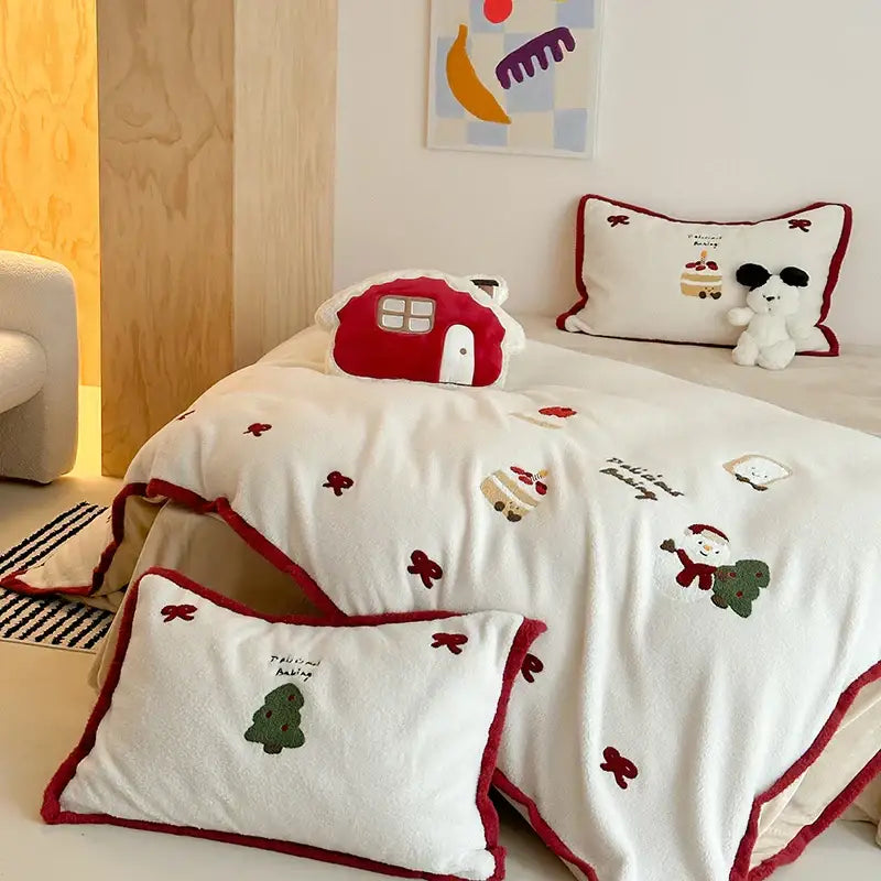 Red and white plush bedding set with cartoon embroidered holiday designs including santa christmas tree and bows for decorbites