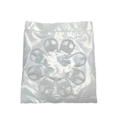 White plastic clip-style fasteners in clear bag for use with red and white espresso machine cleaning brush and kitchen tools