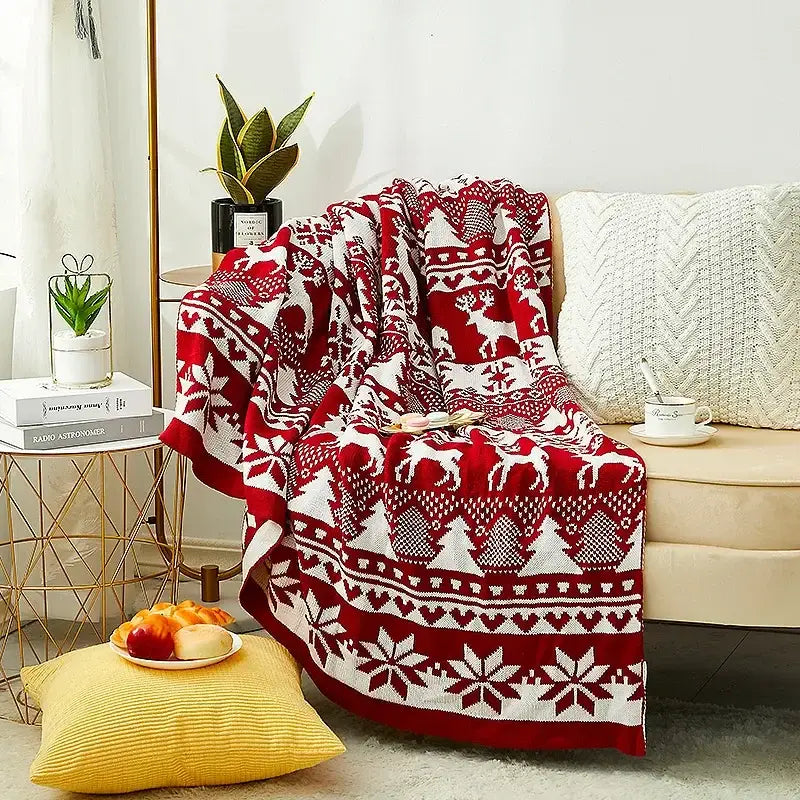 Red and white knitted jacquard christmas tree blanket with festive reindeer and snowflakes pattern for living room decor