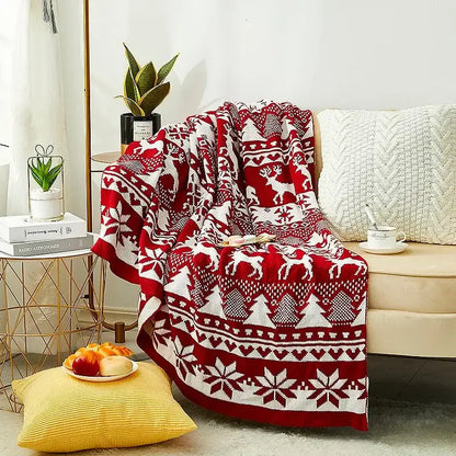 Red and white knitted jacquard christmas tree blanket with festive reindeer and snowflakes pattern for living room decor