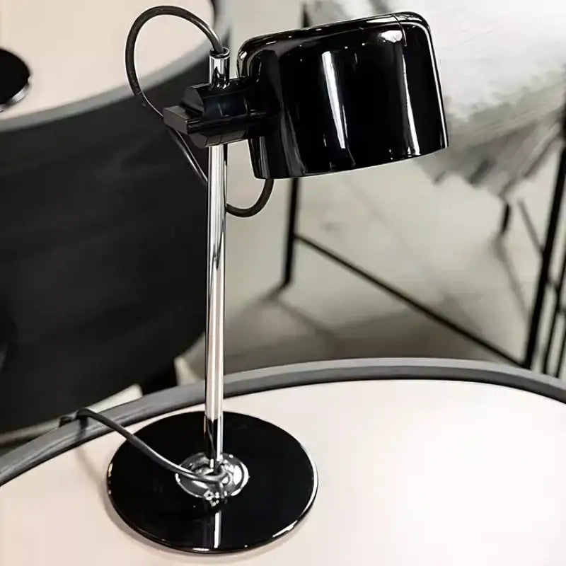 Black glossy ceramic decorbites chrome coupe table lamp with sleek chrome stand and circular base for bedroom decor