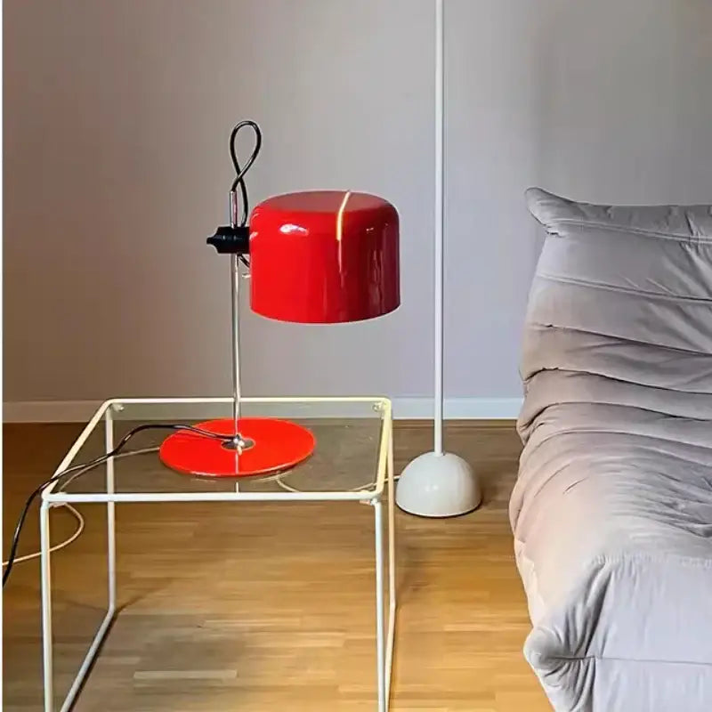 Vibrant red and black chrome coupe table lamp with glossy finish on chrome stand resting on glass table decorbites chrome coupe