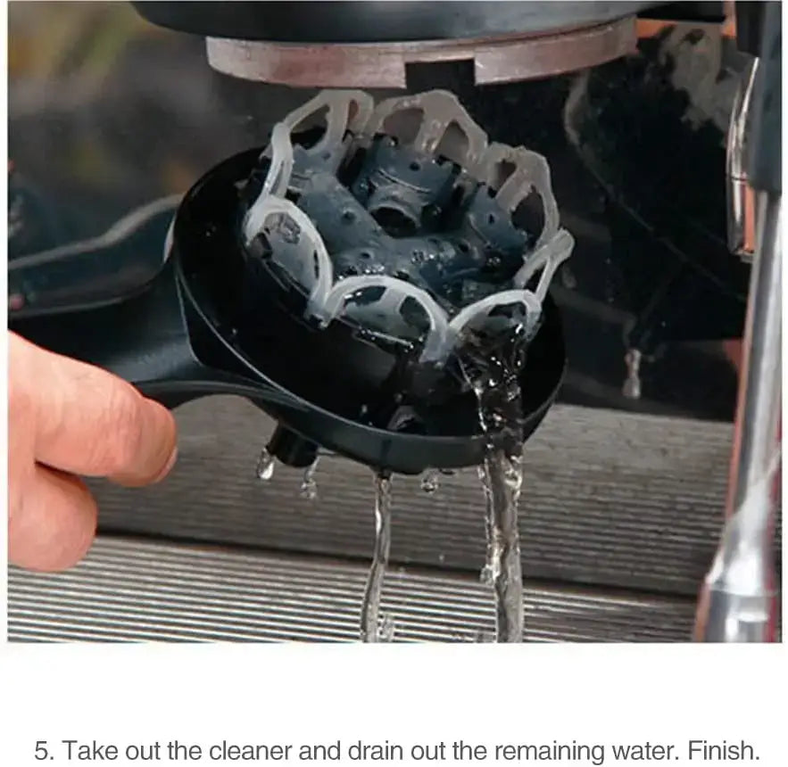 Black plastic espresso machine group head with translucent white cleaning filter attached in Red & black brush cleaner decorbites