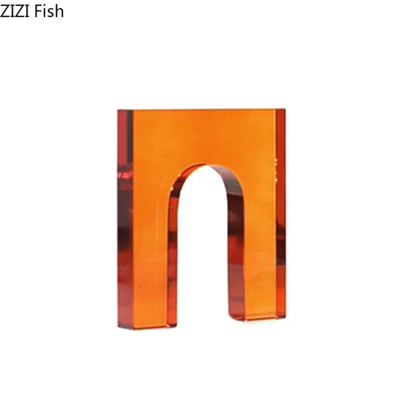 Transparent orange acrylic letter n charm complementing red and blue geometric crystal arch glass sculpture decor