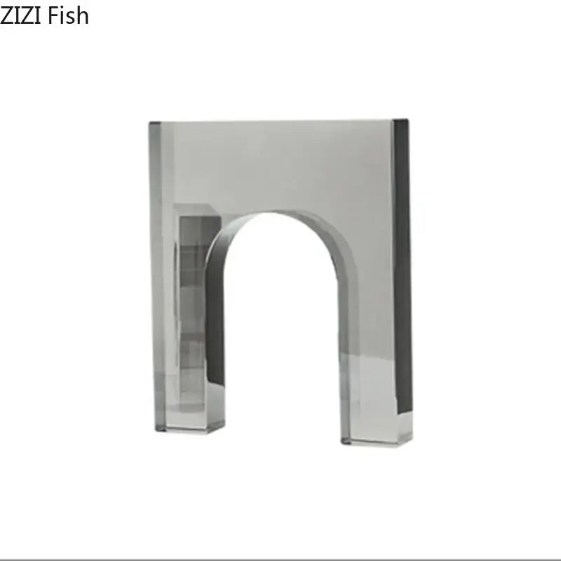 A sleek transparent acrylic crystal arch glass sculpture with polished silver finish and clean geometric lines for living room decor