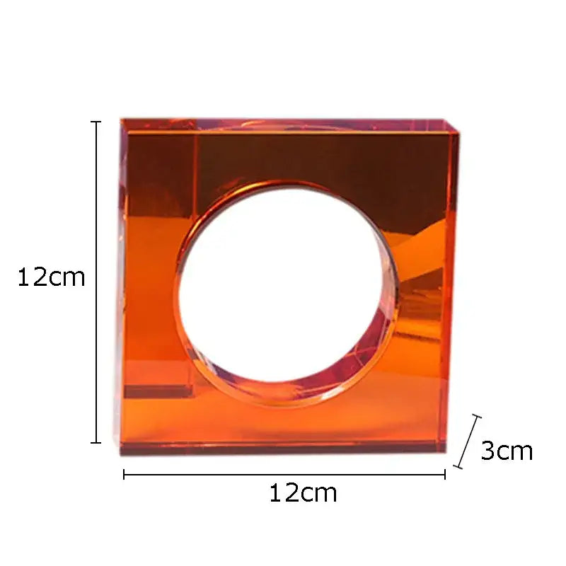 A translucent orange acrylic square centerpiece with circular cutout in a red and blue crystal arch glass sculpture