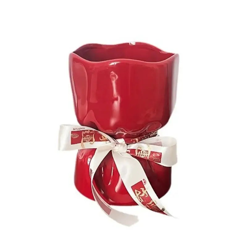 Red bouquet shape ceramic vase with glossy finish scalloped rim and white ribbon with gold chinese characters decorbites bouquet shape