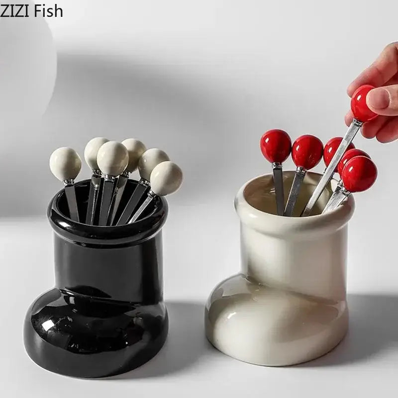Red ceramic boot desk organizer box with black and cream ceramic holders and red and white spherical handles for office storage