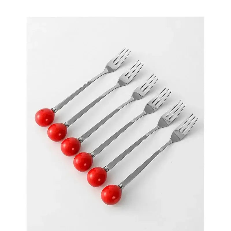 Set of six stainless steel forks with vibrant red ceramic ball handles for use with red ceramic boot desk organizer box
