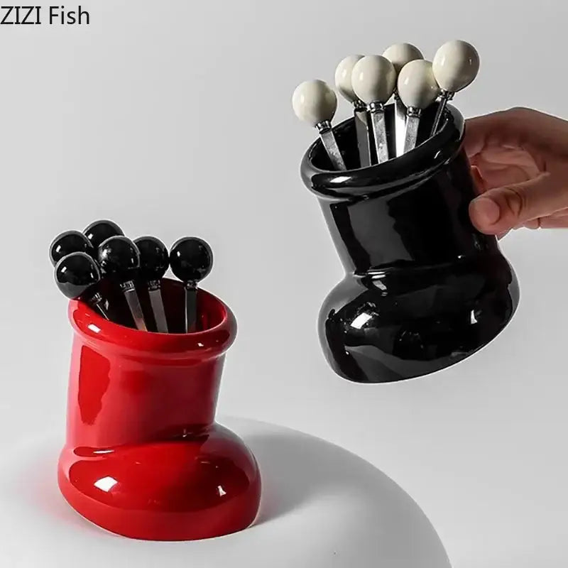 Red and black glossy ceramic boot desk organizer box with matching spherical-topped spoons for office and kitchen storage