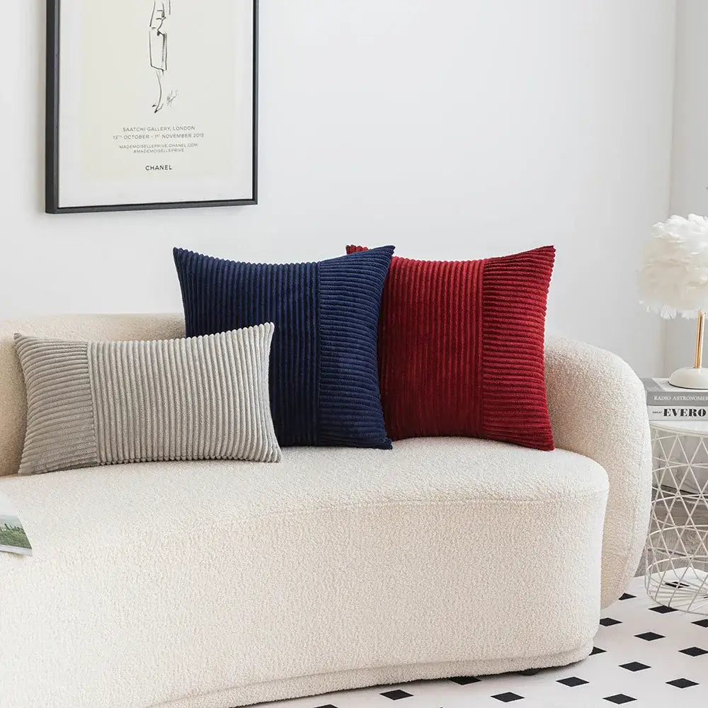 Three corduroy throw pillows in gray navy and red arranged on a cream sofa showcasing decorbites corduroy patchwork cushion covers