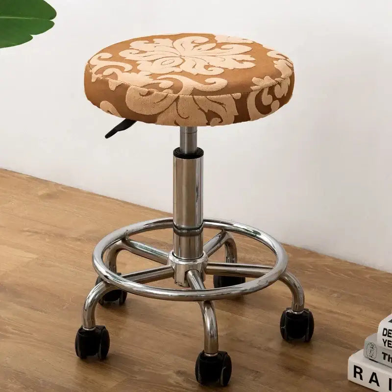 Brown floral-patterned upholstered stool with chrome metal base and casters featuring decorbites jacquard elastic bar chair cover