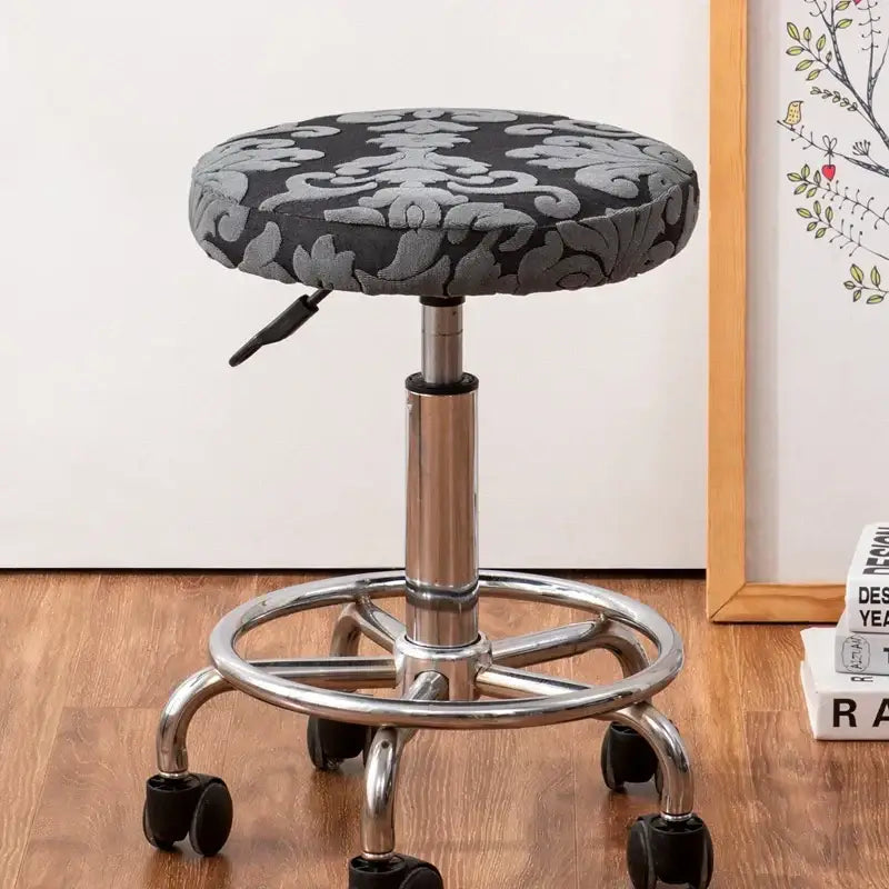 Adjustable height stool with black and gray damask seat and chrome base with casters featuring decorbites jacquard elastic chair cover