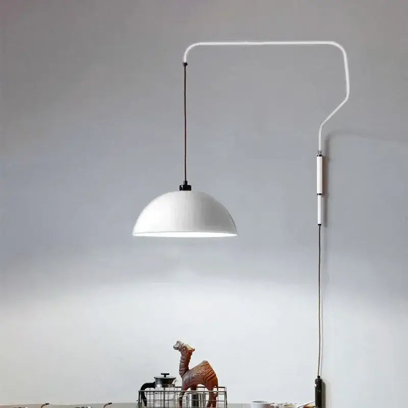 White dome-shaped adjustable pendant light with sleek curved arm and black cord for kitchen island use