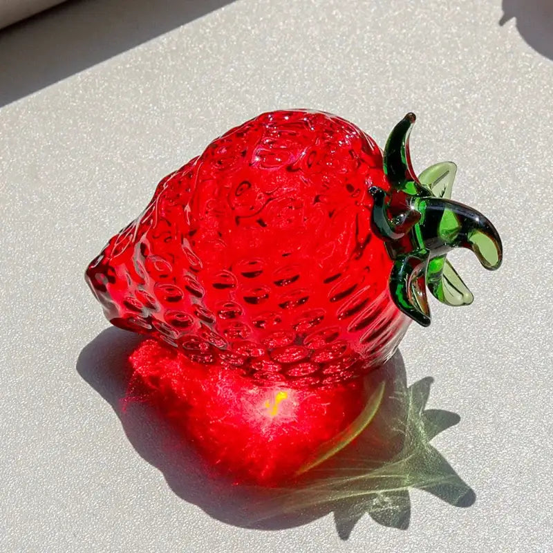 Red glass strawberry figurine with vibrant translucent red fruit and green leafy stem crystal fruit ornament