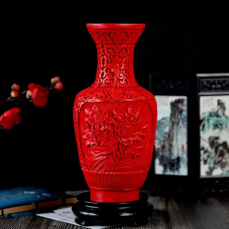 Vibrant red lacquerware flower auspicious vase with intricate dragon carving displayed on dark wooden stand