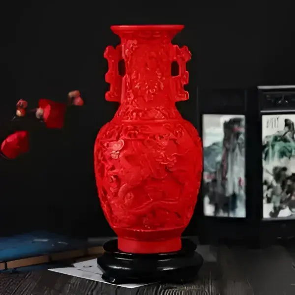 Red lacquerware flower auspicious vase with intricate dragon carvings and dual handles on a black circular base