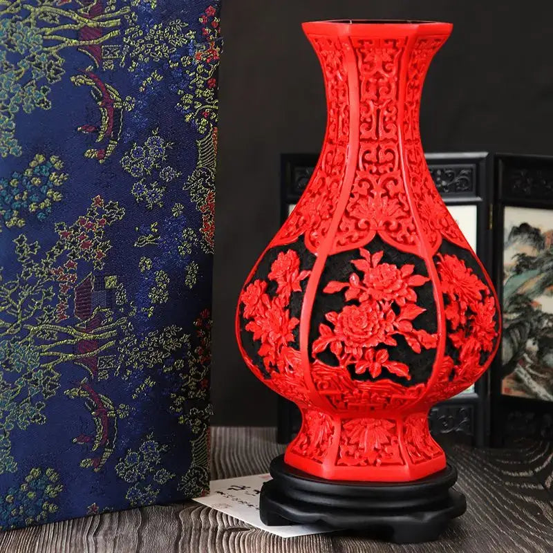 Vibrant red lacquerware flower auspicious vase with intricate dragon carving on dark wooden base for living room display