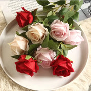 A bouquet of red pink and cream dried roses artificial flowers on a white plate for wedding decorbites dried roses decor