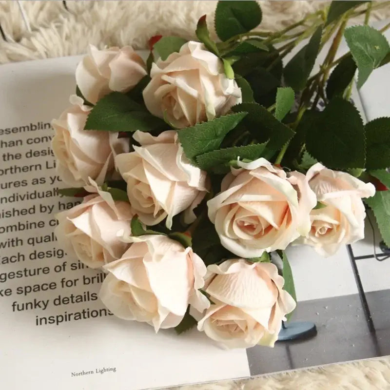A bouquet of peach-colored dried roses artificial flowers with green leaves from decorbites dried roses wedding decor