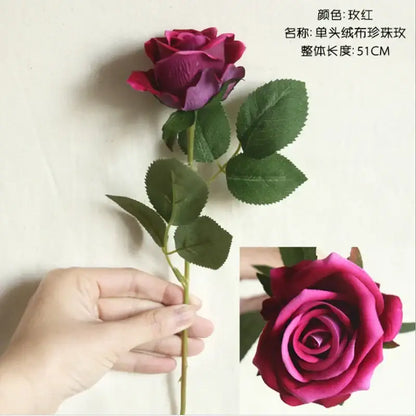 A single-stem decorbites dried roses artificial fabric rose with deep burgundy petals and green leaves for wedding decor