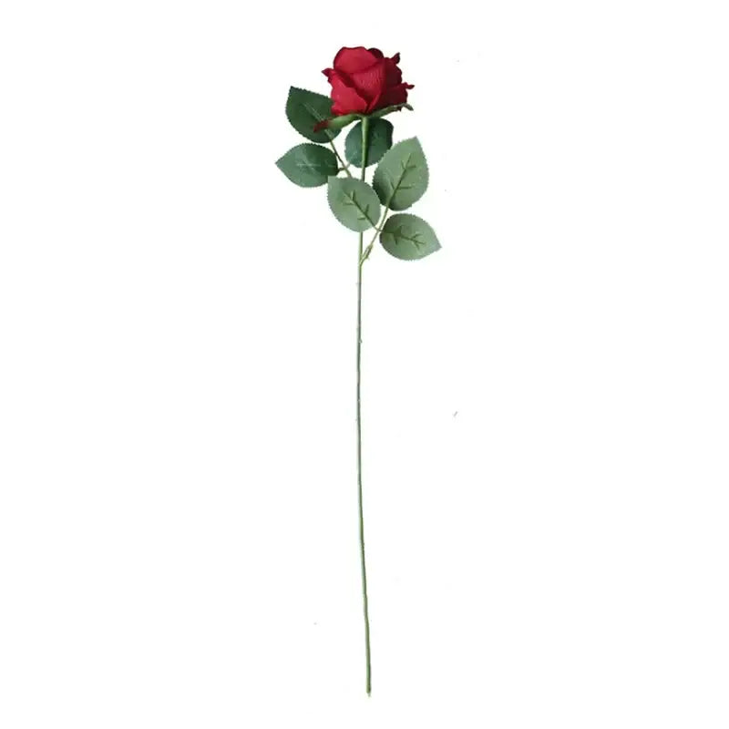 A single vibrant red artificial rose with glossy green leaves in decorbites dried roses artificial wedding decor