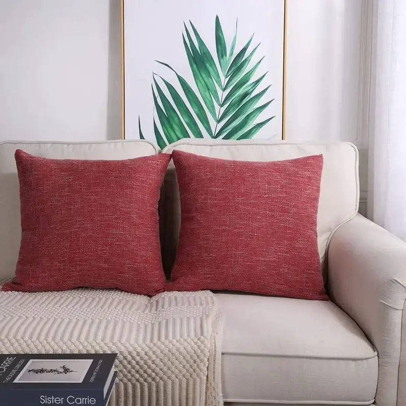 Two red textured linen throw pillow covers rest on a beige sofa enhancing living room decorbites linen throw decor
