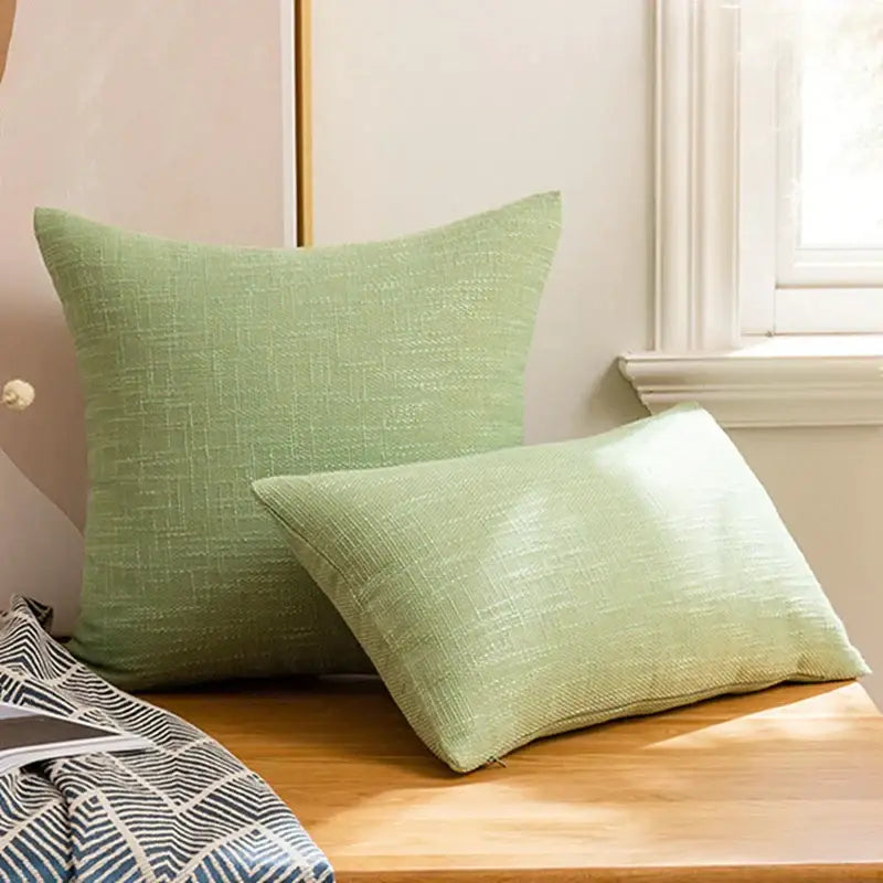 Two light green decorbites linen throw pillow covers with subtle woven texture for living room decor