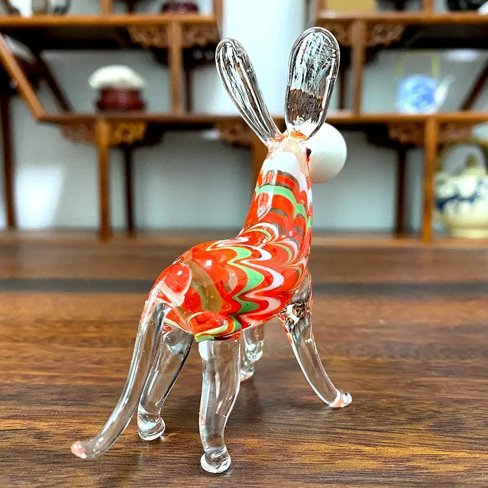 A vibrant red white and green swirl glass donkey figurine handcrafted for elegant living room decor