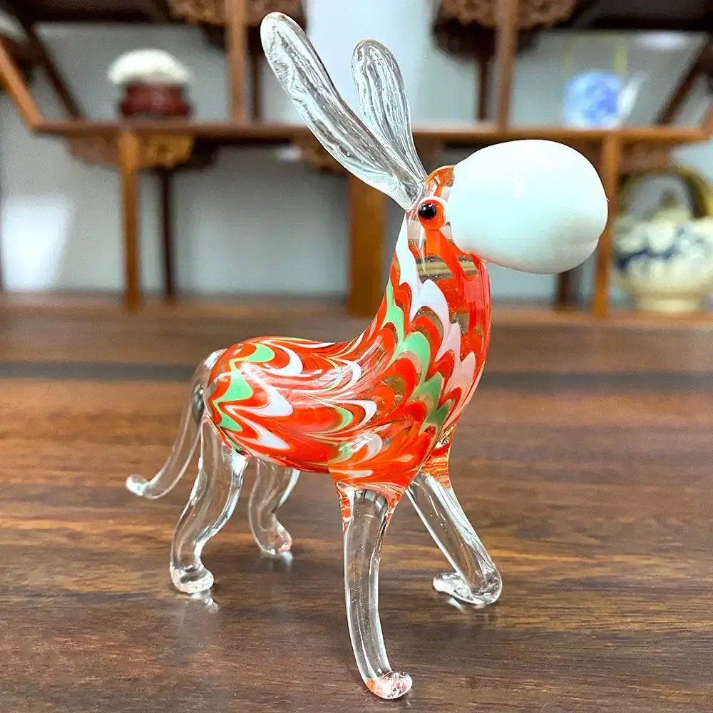 A vibrant glass donkey figurine with red white and green swirl patterns and transparent antlers for living room decor