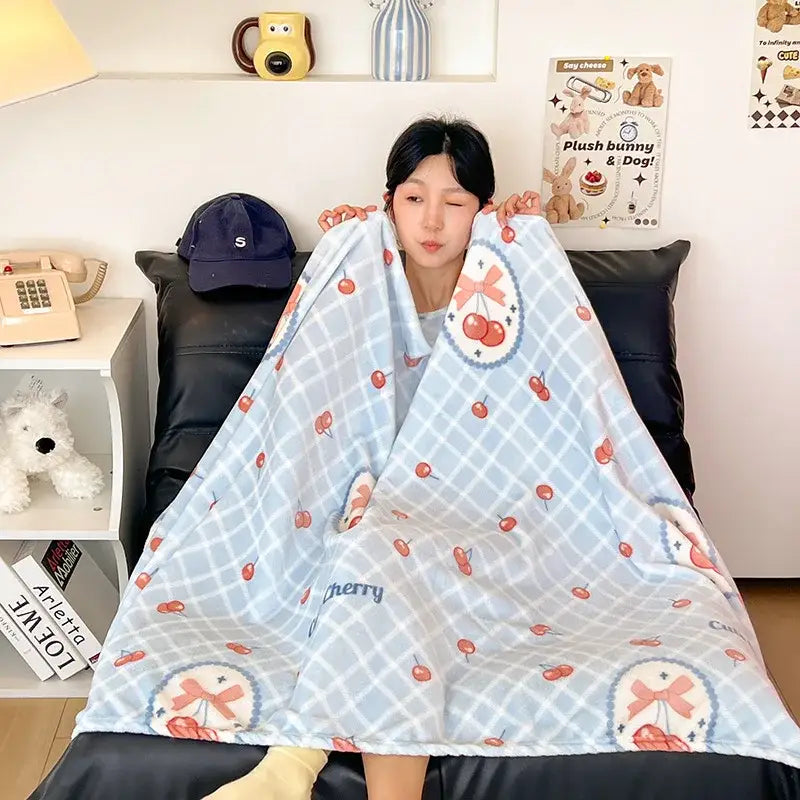 A soft light blue velvet printed blanket with cherry and white checkered design for bedroom decor