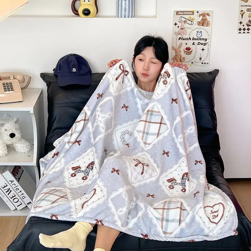 A soft light gray velvet printed blanket with quilted playful patterns suitable for bedroom decor