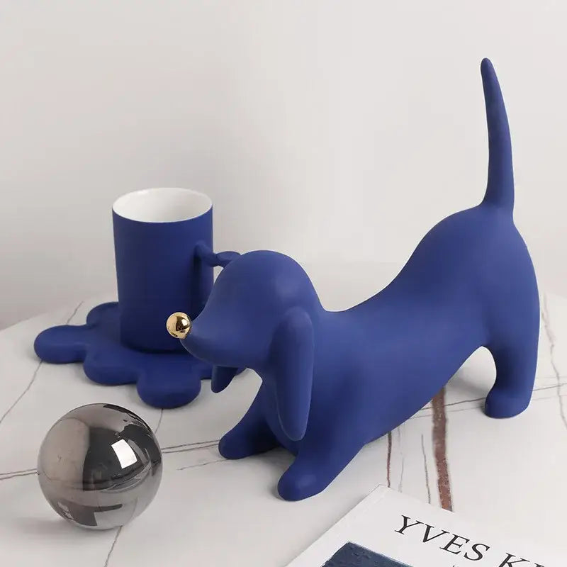 A sleek matte blue ceramic dachshund figurine with gold nose and tail for home decor and decorbites doberman art statue