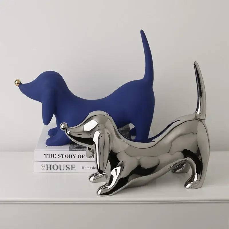 A sleek reflective silver dachshund art statue with polished metallic finish for home decor and decorbites doberman collection