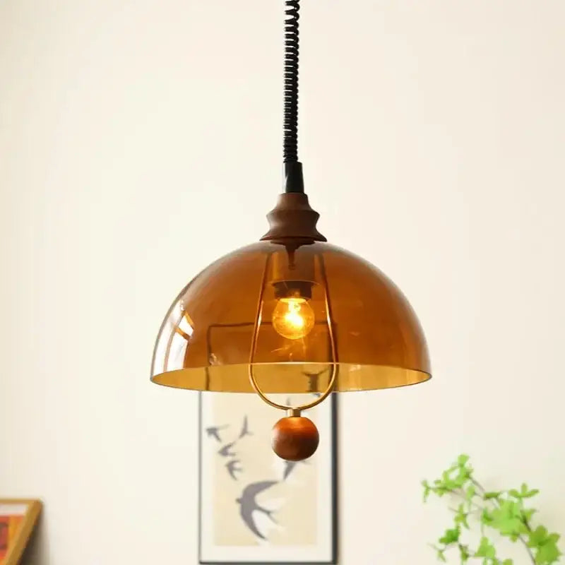 Warm amber glass pendant light with brass accent and wooden bead for dining room decorbites amber shades retro style