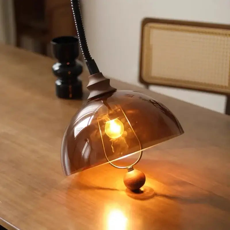 Warm amber glass dome pendant light with brass base and black gooseneck for retro amber shades decorbites style