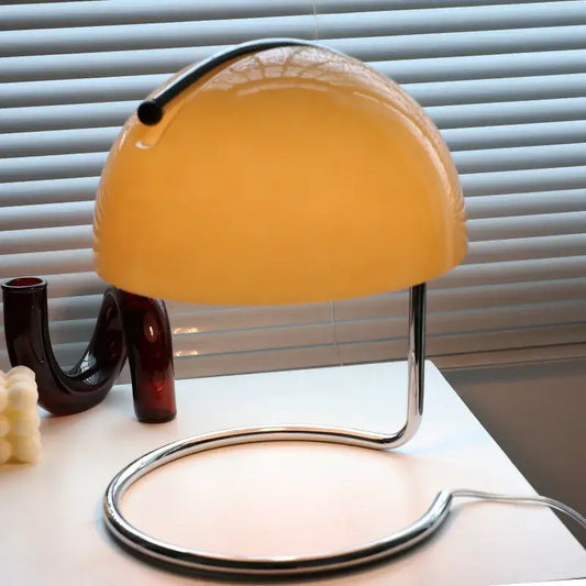 A sleek retro amber glass table lamp with curved chrome handle and base by decorbites glass table decor