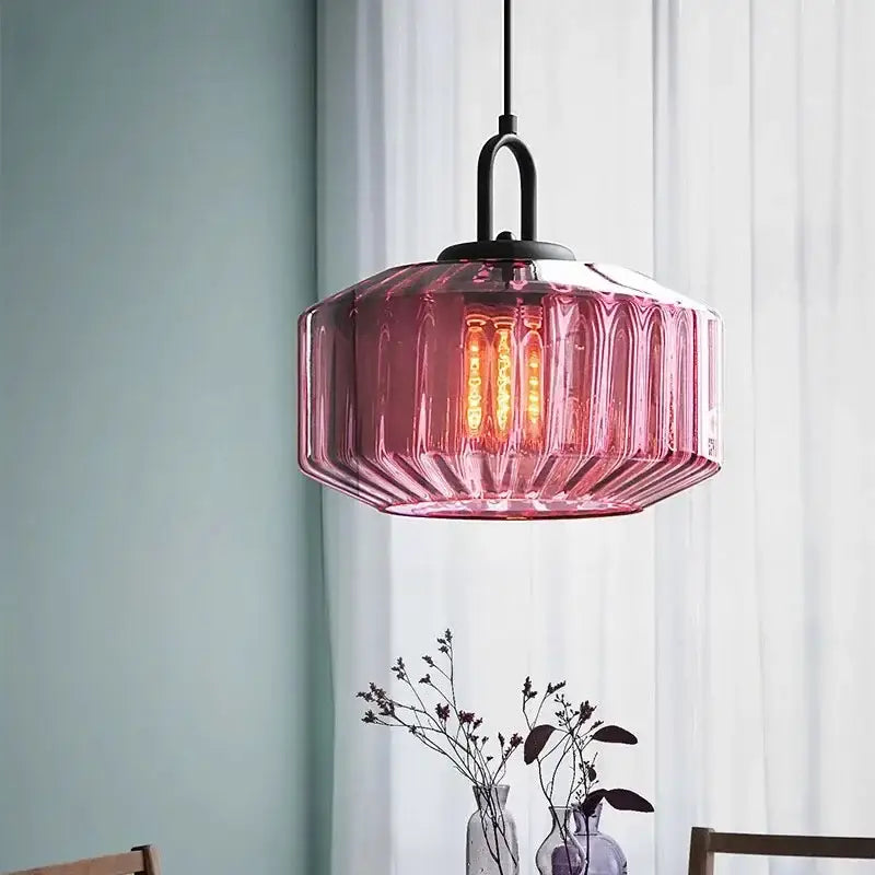 A pink faceted glass pendant light with black metal fixture perfect for color glass dining chandelier decorbites