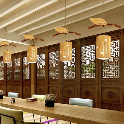 Natural bamboo art chandelier featuring leaf-shaped warm-toned shades in wood for dining room pendant lighting