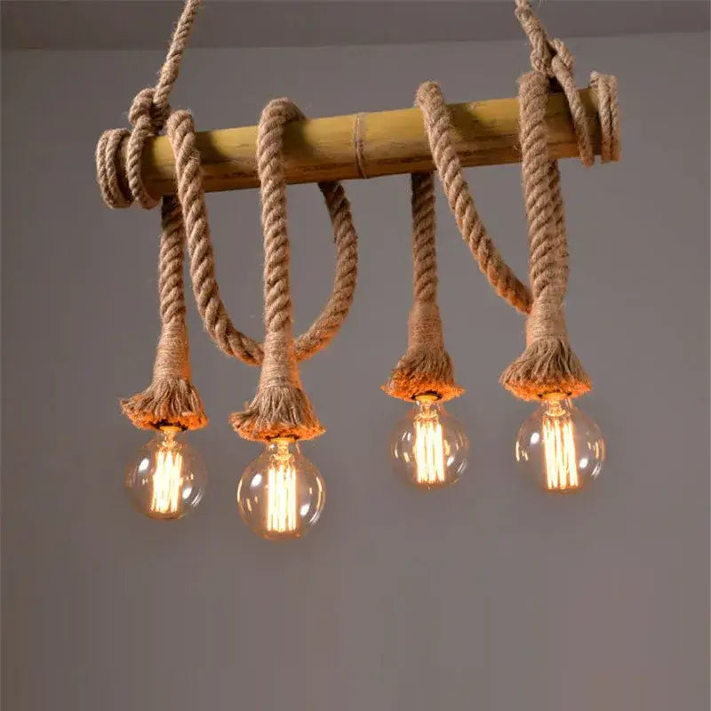 Rustic pendant lights featuring rope wrapped bamboo hemp rope with four glowing filament bulbs for dining room decorbites bamboo hemp chandelier