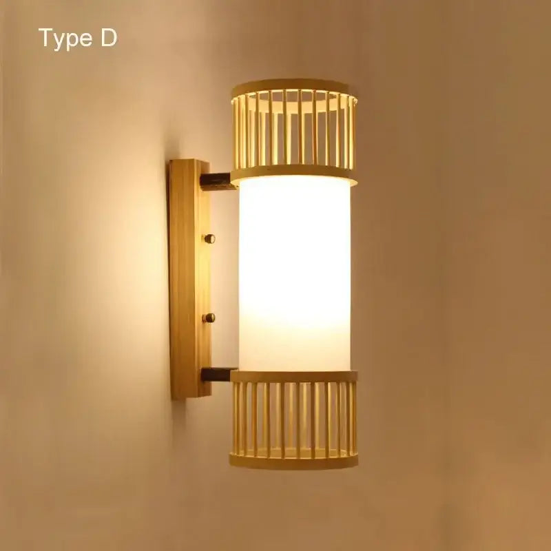 Warm-toned bamboo wall lights with a hand woven rattan frame and frosted glass cylinder for bedroom use