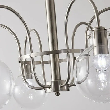 Stylish retro bauhaus brass glass led chandelier with brushed nickel curved metal arms and clear glass globe shades for dining room