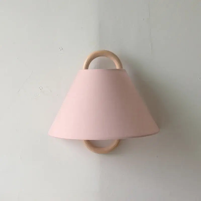 Soft pink conical lampshade retro beech wood wall lamp with natural wood ring handle and base for bedroom use
