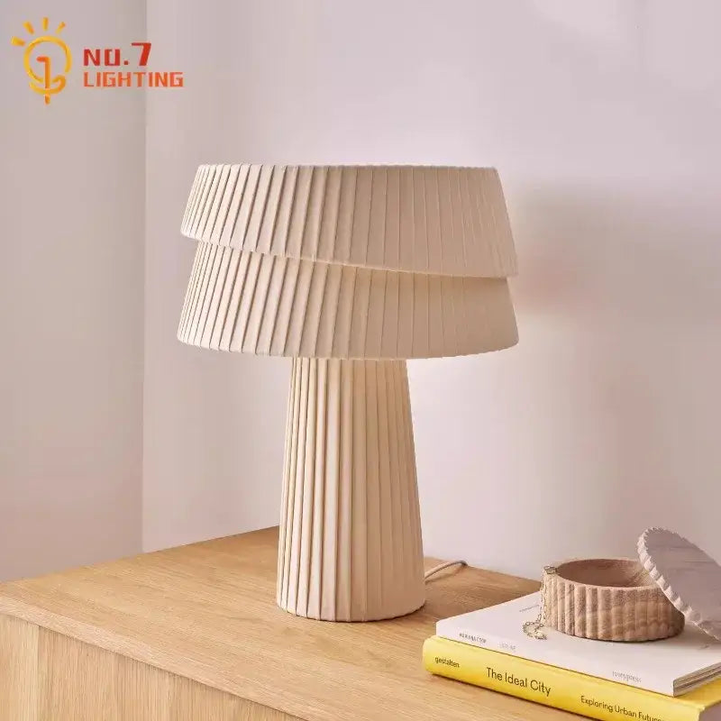 Beige pleated table lamp with tiered fluted design and matte finish for bedroom atmosphere cream wind mushroom decorbites