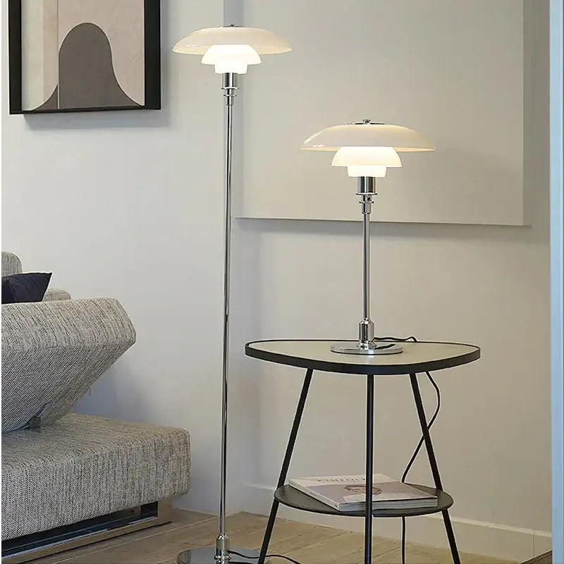 A sleek retro black floor lamp with polished chrome and layered white glass shade led for living room use